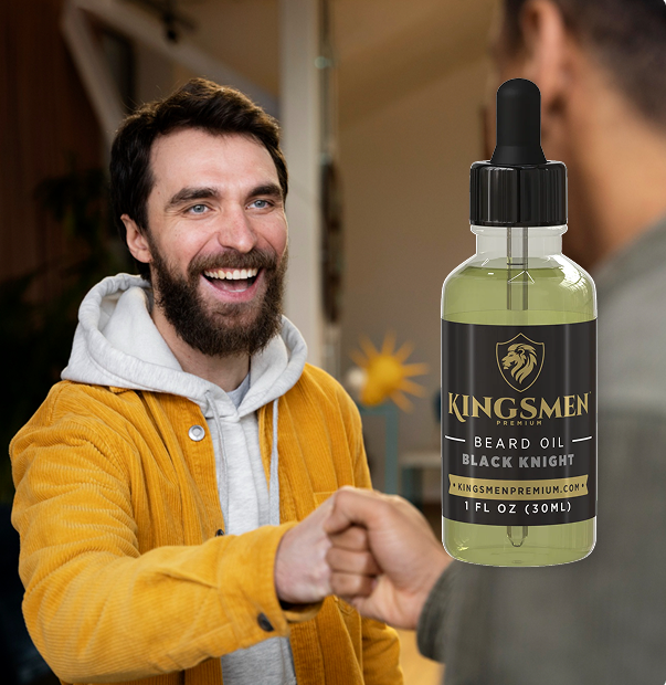 A man in a yellow jacket and white hoodie fist-bumps another person while a bottle of Kingsmen Beard Oil Black Knight is shown prominently on the right against a blurred indoor background.