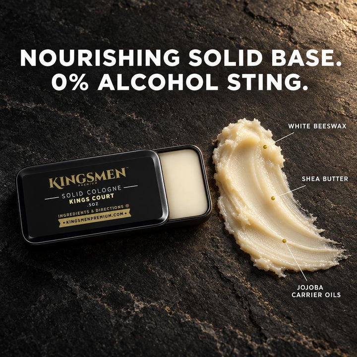 Open Kingsmen solid cologne tin beside a smear of golden-ivory balm on dark stone, with labels pointing to its ingredients: white beeswax, shea butter and jojoba carrier oils. White headline reads: Nourishing solid base. 0% alcohol sting. - Thumbnail